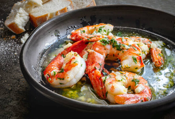istockphoto-1365258650-612x612 Garlic prawns or shrimp in black rustic bowl, with crusty bread.  Delicious buttery shellfish.
